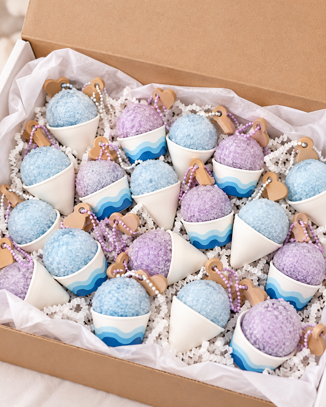 Blue and lavender shave ice clickers packed in a gift box for a first birthday