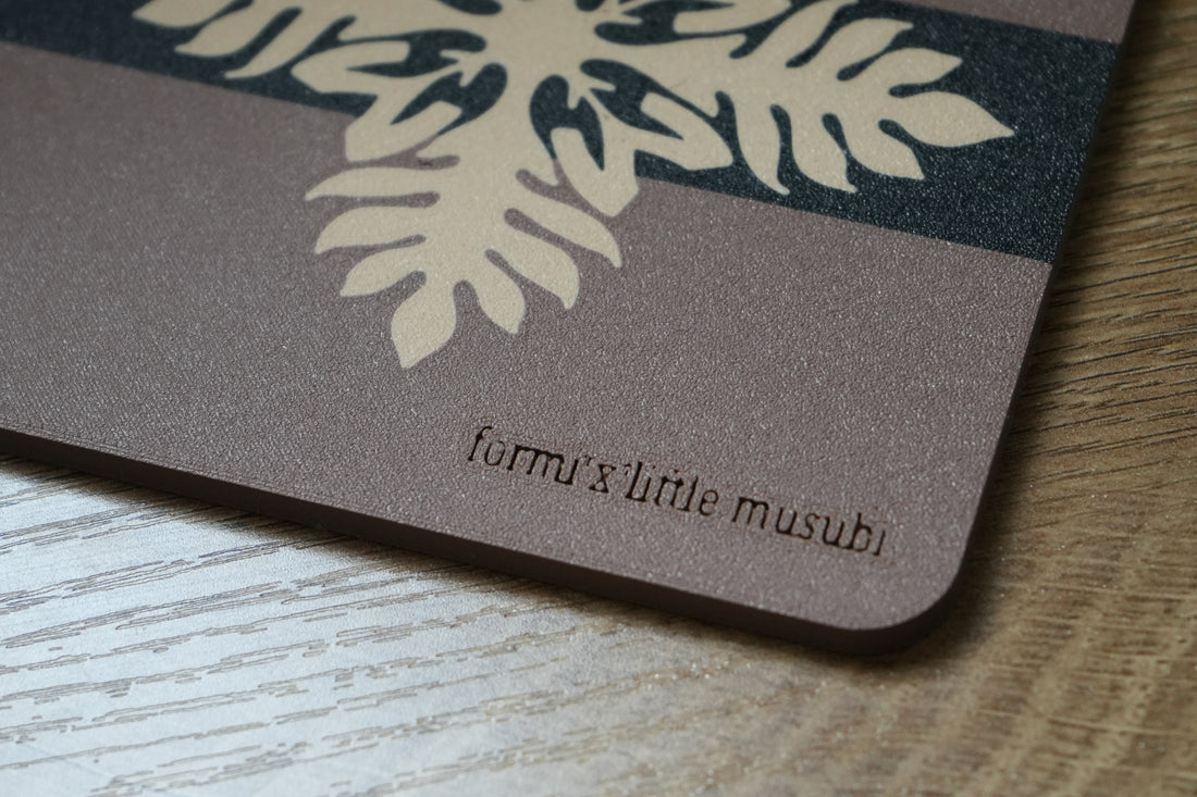 Close-up of the Formi x Little Musubi name on a musubi-inspired coaster