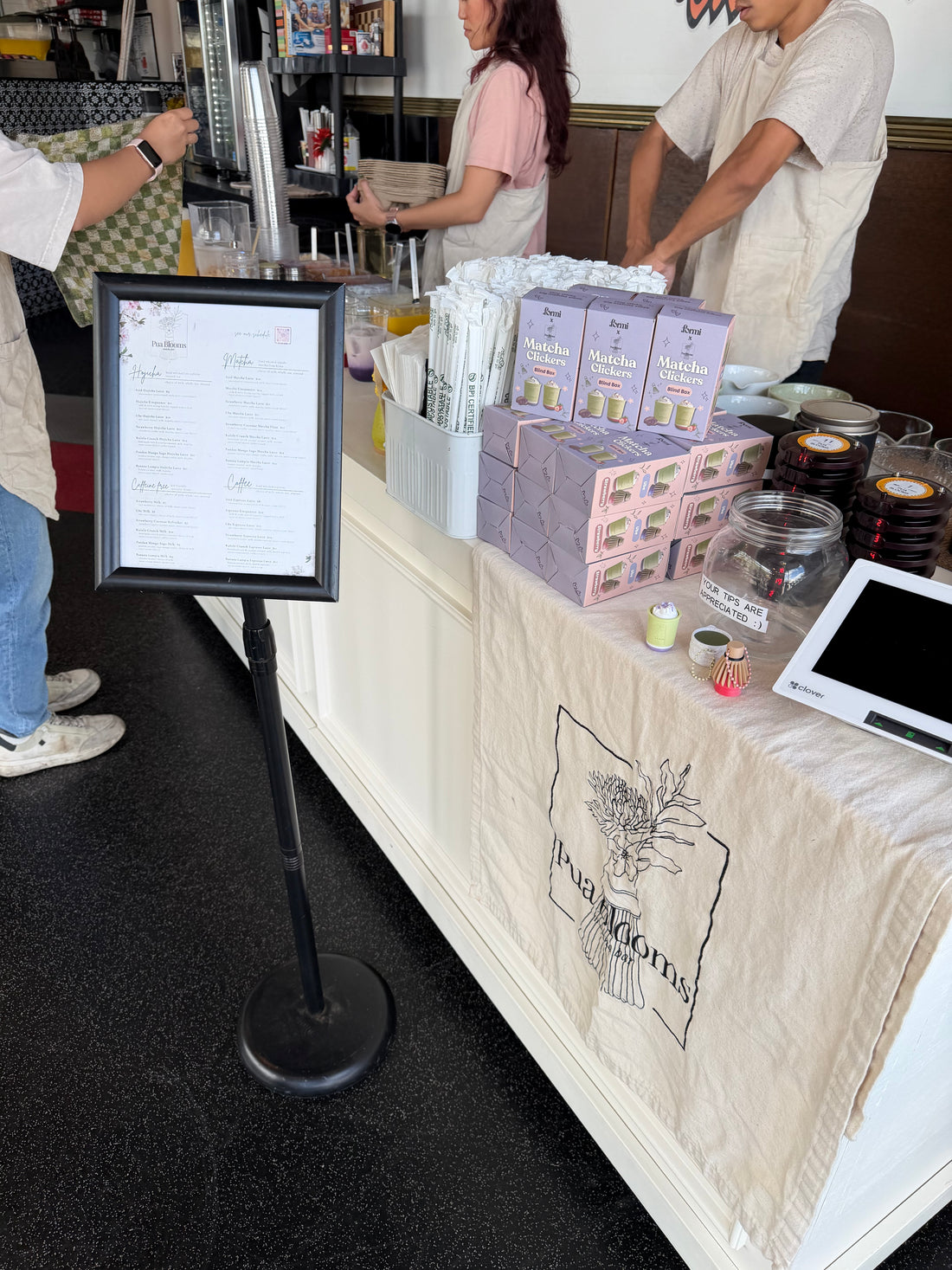 Formi x Pua Blooms matcha clicker packaging displayed beside the Pua Blooms drink menu